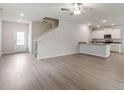 Open floor plan with wood floors flowing from living room to kitchen at 601 Benton Dr, Oxford, NC 27565