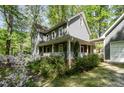 Charming home featuring a welcoming front porch and lush landscaping at 6105 Splitrock Trl, Apex, NC 27539