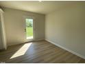 Bright, sunlit area featuring wood-look flooring, adjacent to outside, great for entertaining at 70 Pate Landing Dr, Selma, NC 27576