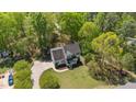 An aerial view of the house shows its landscaped lawn, mature trees, driveway, and inviting front porch at 720 Raymond Dr, Clayton, NC 27527