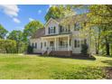 This lovely two-story house features a welcoming front porch, clean lines and black shutters at 720 Raymond Dr, Clayton, NC 27527