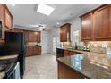 Well-lit kitchen with granite countertops, stylish cabinetry, and stainless steel appliances at 720 Raymond Dr, Clayton, NC 27527