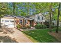 View of a two-story home's exterior, complete with a driveway and lush green front lawn at 730 N Harrison Ave, Cary, NC 27513