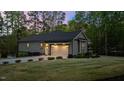 Side view of the home showcasing an attached garage and manicured lawn at 775 Sagamore Dr, Louisburg, NC 27549