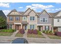 Charming townhome exterior with stone accents and a well-manicured front yard at 7822 Allscott Way, Raleigh, NC 27612