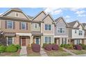 Charming townhome exterior with stone accents and a well-manicured front yard at 7822 Allscott Way, Raleigh, NC 27612