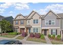 Charming townhome exterior with stone accents and a well-manicured front yard at 7822 Allscott Way, Raleigh, NC 27612