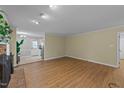 Open living room with hardwood floors, neutral walls, and direct access to the kitchen at 801 Silver Leaf Pl, Raleigh, NC 27609