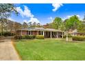 Classic brick house with lush green lawn, beautiful landscaping, and a welcoming front porch at 806 S Second St, Smithfield, NC 27577