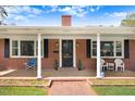 Inviting front porch with classic brickwork, white columns, and seating area enhancing the curb appeal at 806 S Second St, Smithfield, NC 27577