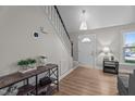 Bright entryway with wood floors, staircase, console table, and a view of the front door at 8333 Bellingham Cir, Raleigh, NC 27615