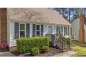 Close-up of a home's inviting front entrance with manicured landscaping and stylish accents at 8333 Bellingham Cir, Raleigh, NC 27615