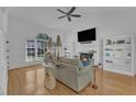 Bright living room with hardwood floors, a fireplace, vaulted ceiling, and natural light at 8721 Attingham Dr, Raleigh, NC 27615