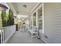 Inviting front porch with rocking chair and bench seating at 904 Coral Bell Dr, Wake Forest, NC 27587