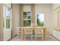 Cozy dining room featuring light wood table and chairs, with natural light and simple decor at 92 Glencoe Ln, Zebulon, NC 27597