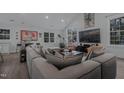 Comfortable living room boasts vaulted ceilings, expansive windows, and a large sectional sofa at 1001 Manchester Dr, Raleigh, NC 27609
