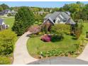 Stunning aerial view of a beautifully landscaped home with a circular driveway at 1008 Maduro Ct, Zebulon, NC 27597