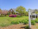 Well-manicured front yard with vibrant flowers and a classic mailbox at 1008 Maduro Ct, Zebulon, NC 27597