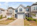 Well-maintained townhome exterior features a garage, lush landscaping, and a welcoming curb appeal at 1020 Sycaten St, Durham, NC 27703
