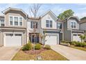 Charming townhome exterior features a garage, attractive landscaping, and well-kept lawn for curb appeal at 1020 Sycaten St, Durham, NC 27703