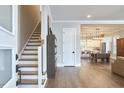 Inviting foyer showcasing hardwood floors, staircase, and an open view to the dining area and kitchen, seamlessly connecting living spaces at 107 Hillcrest Ave # C And D, Carrboro, NC 27510