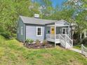 A quaint single-story home with a gray exterior, white trim, and a welcoming front porch at 111 Dunstan Ave, Durham, NC 27707