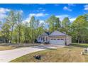 Well maintained home, set back on a large lot, with a long driveway and mature trees at 119 Wolf Creek Dr, Wendell, NC 27591