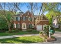 Beautiful brick home featuring a two-car garage, green shutters, and a pristine front lawn at 1216 Caribou Xing, Durham, NC 27713