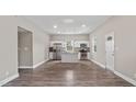 Open-concept kitchen with stainless steel appliances, an island, and sleek white cabinetry at 1284 Railroad St, Henderson, NC 27536