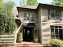 Inviting home exterior featuring a black front door, decorative shutters and brick steps leading to entrance at 1425 Bascomb Dr, Raleigh, NC 27614