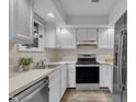 A modern kitchen features stainless steel appliances, white cabinets, and light countertops at 1442 Barton Place Dr, Raleigh, NC 27608