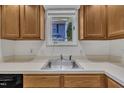 Close-up of the kitchen sink with oak cabinets and laminate countertops at 1442 Barton Place Dr, Raleigh, NC 27608