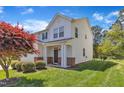 Charming two-story home with a well-manicured front lawn and a two-car garage on a sunny day at 145 Ryder Cup Cir, Raleigh, NC 27603