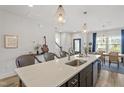 Open kitchen with a large island, pendant lighting, barstool seating, and modern fixtures at 1526 Millrock Trl, Wendell, NC 27591