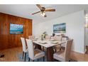 Cozy dining room featuring wood paneling, a modern light fixture, and a marble table with seating for six at 1813 Grady Dr, Durham, NC 27712