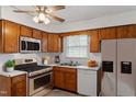 Efficient kitchen with stainless steel appliances, wooden cabinets, and ample counter space with natural light at 1813 Grady Dr, Durham, NC 27712