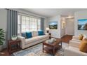 Bright living room with a large window, hardwood floors, a comfortable couch, and elegant decor at 1813 Grady Dr, Durham, NC 27712