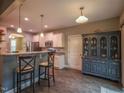 A view of the kitchen with breakfast bar, granite counters, and a wet bar, perfect for entertaining at 198 Shadowbark Dr, Garner, NC 27529