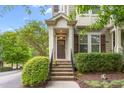 Inviting entrance featuring brick steps, mature landscaping, and a welcoming front door at 214 S Camellia St, Chapel Hill, NC 27516