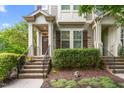 Inviting entrance featuring brick steps, mature landscaping, and a welcoming front door at 214 S Camellia St, Chapel Hill, NC 27516