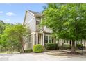 Charming two-story townhome featuring a well-maintained lawn and a welcoming front porch at 214 S Camellia St, Chapel Hill, NC 27516