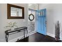 Bright foyer with dark wood floors, decorative mirror and a stylish console table at 216 Bella Rose Dr, Chapel Hill, NC 27517