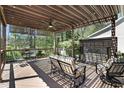 Relaxing outdoor deck with a pergola, ceiling fan, and cozy seating area at 216 Bella Rose Dr, Chapel Hill, NC 27517