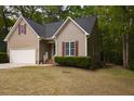Side view of cozy home featuring manicured lawn and neutral siding with red shutters at 216 Harvester Dr, Holly Springs, NC 27540