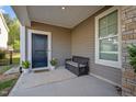 Inviting front porch featuring a dark bench, a window, and a welcoming entryway at 218 Maple Walk St, Durham, NC 27703