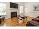 Inviting living room with a cozy fireplace, hardwood floors, and bright windows at 2213 Ravens Creek Ct, Raleigh, NC 27603