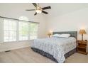 Serene main bedroom with vaulted ceilings, large windows, and a calming color palette at 2213 Ravens Creek Ct, Raleigh, NC 27603