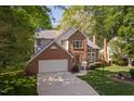 Charming brick home with manicured lawn, surrounded by lush trees creating a picturesque setting at 2221 Dungiven Ct, Garner, NC 27529