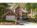 Lovely brick home with an attached garage, surrounded by green lawn and mature trees at 2221 Dungiven Ct, Garner, NC 27529