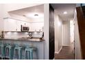 Bright, updated kitchen with white cabinets, granite countertops, and barstool seating at 26 Stonewall Way, Durham, NC 27704